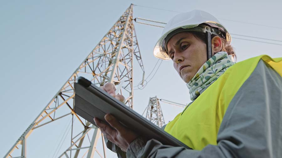 High voltage female engineer working on the field. Collecting AI field data using Fulcrum.