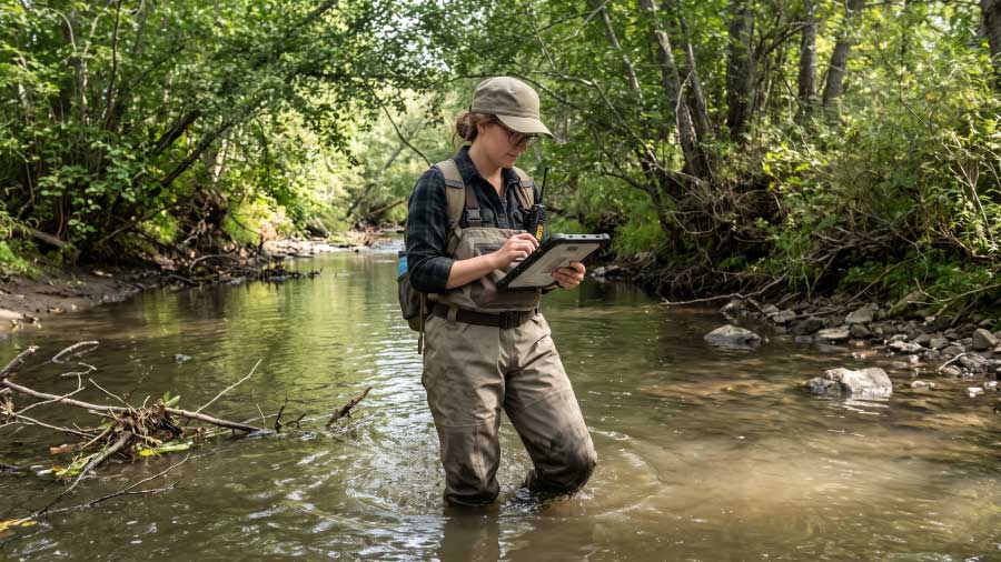 Ecologist In Waders Performing A Wetland Study Using A Tablet How Consultants Use Fulcrum To Prove Environmental Impact Blog