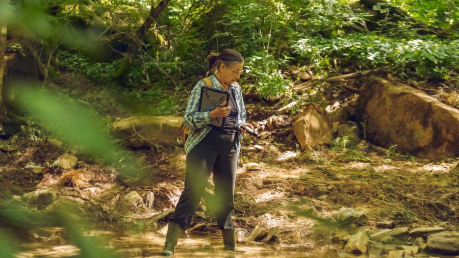 Ecologist Performing River Study Using A Tablet How Consultants Use Fulcrum To Prove Environmental Impact Feature