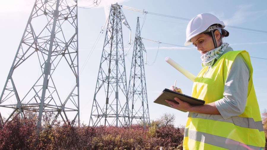 Electrical Technician With Tablet By High Voltage Tower Ulcrum And Slalom Partnership Brings Ai To Utility Field Operations