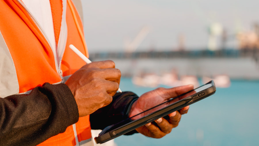 Man In Hi Vis Vest Using Tablet To Peform Field Operations How The Fulcrum And Slalom Partnership Brings Ai To Utility Field Operations